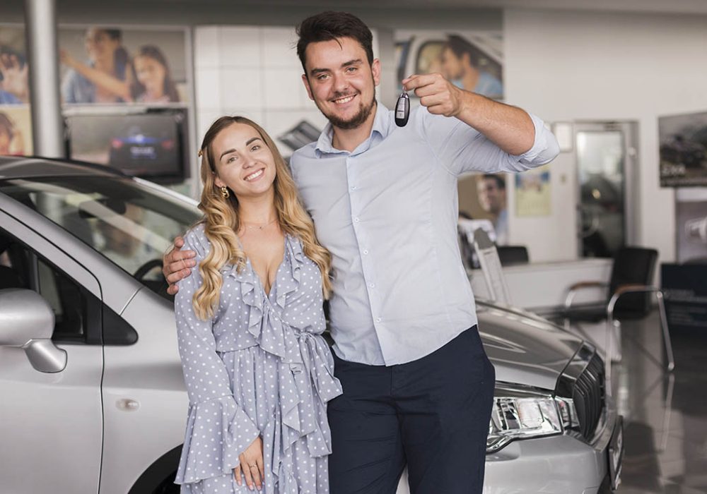 front-view-happy-couple-holding-car-keys